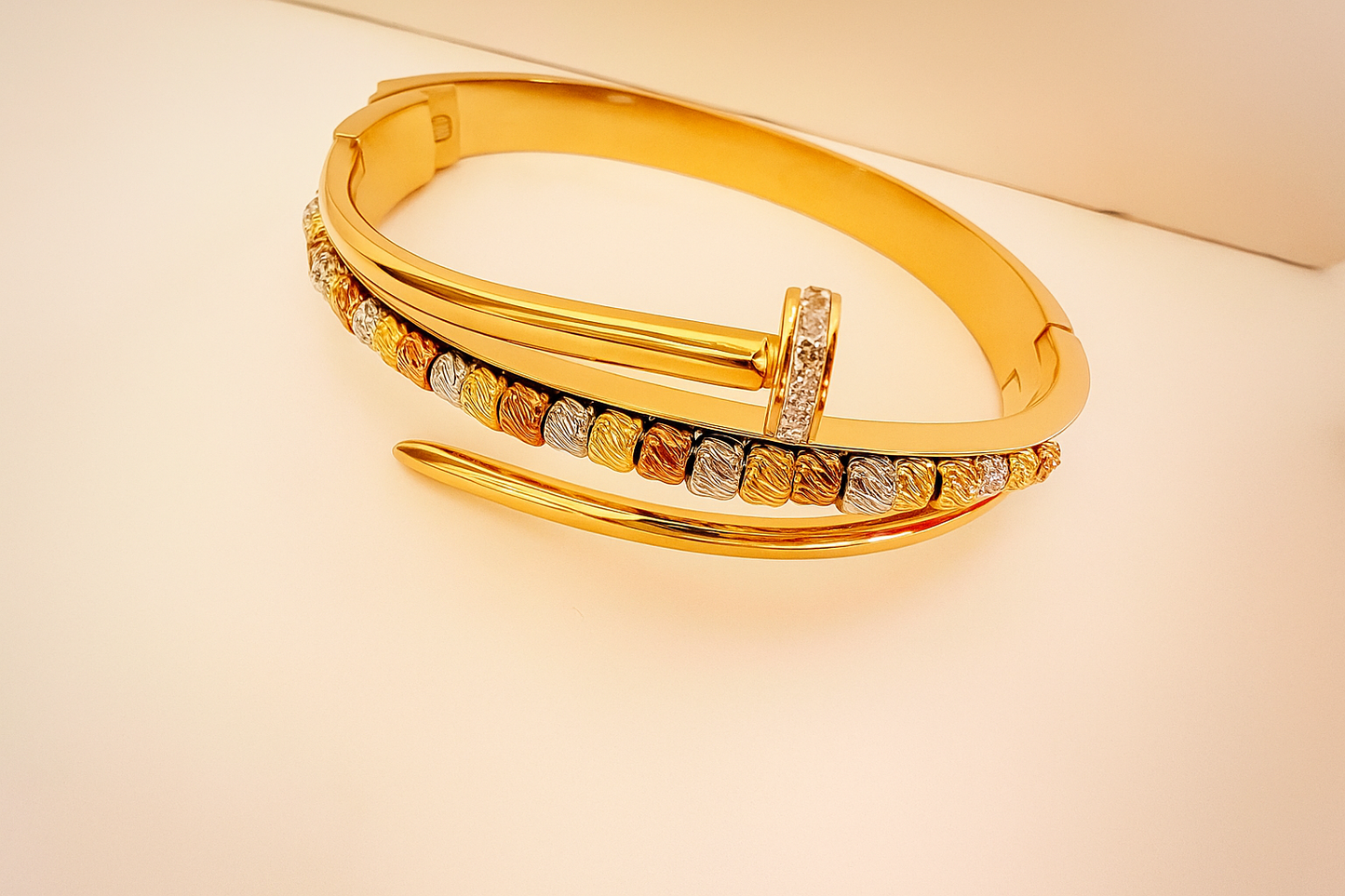 Gold Bronze Bangle featuring a sleek, modern design with a blend of gold and bronze tones accented by small textured details and subtle sparkle, ideal for luxury jewellery collections.