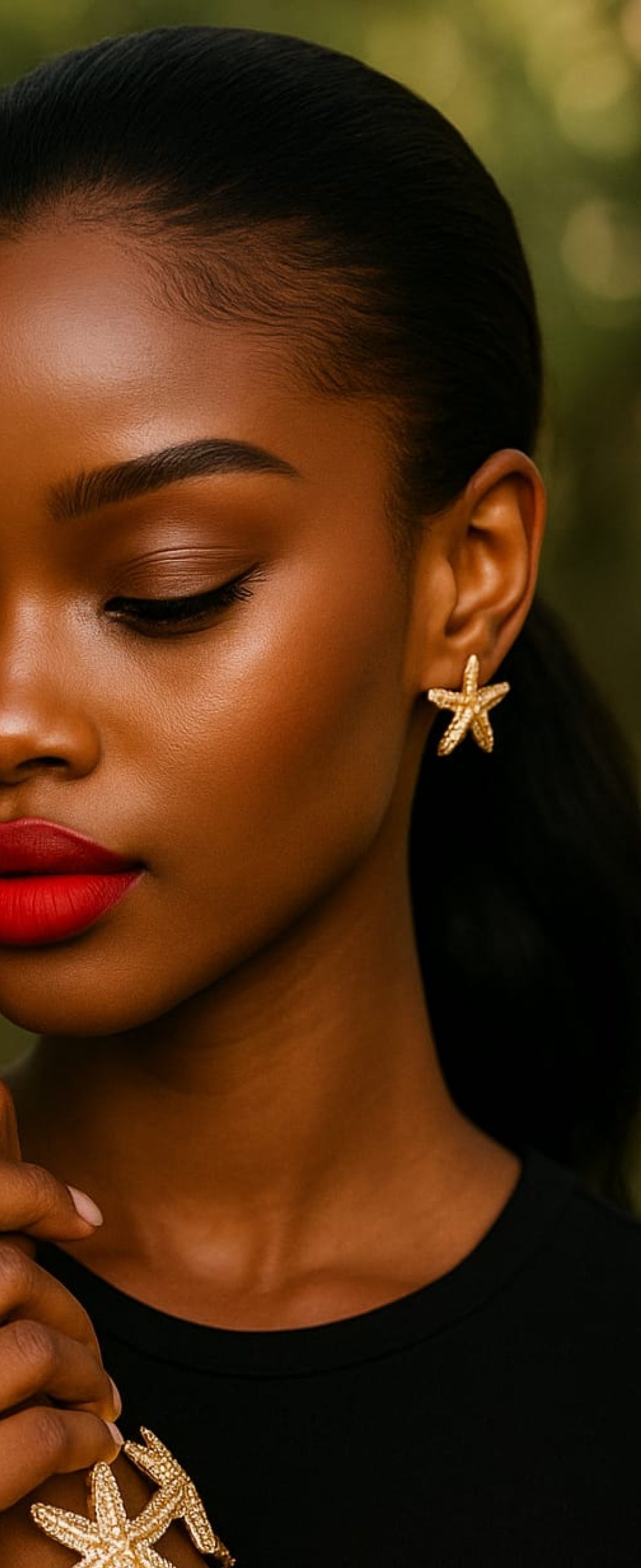 Close-up of a woman wearing gold Star fish Earrings with intricate texture, paired with matching jewelry, highlighting elegant and luxurious accessory style.