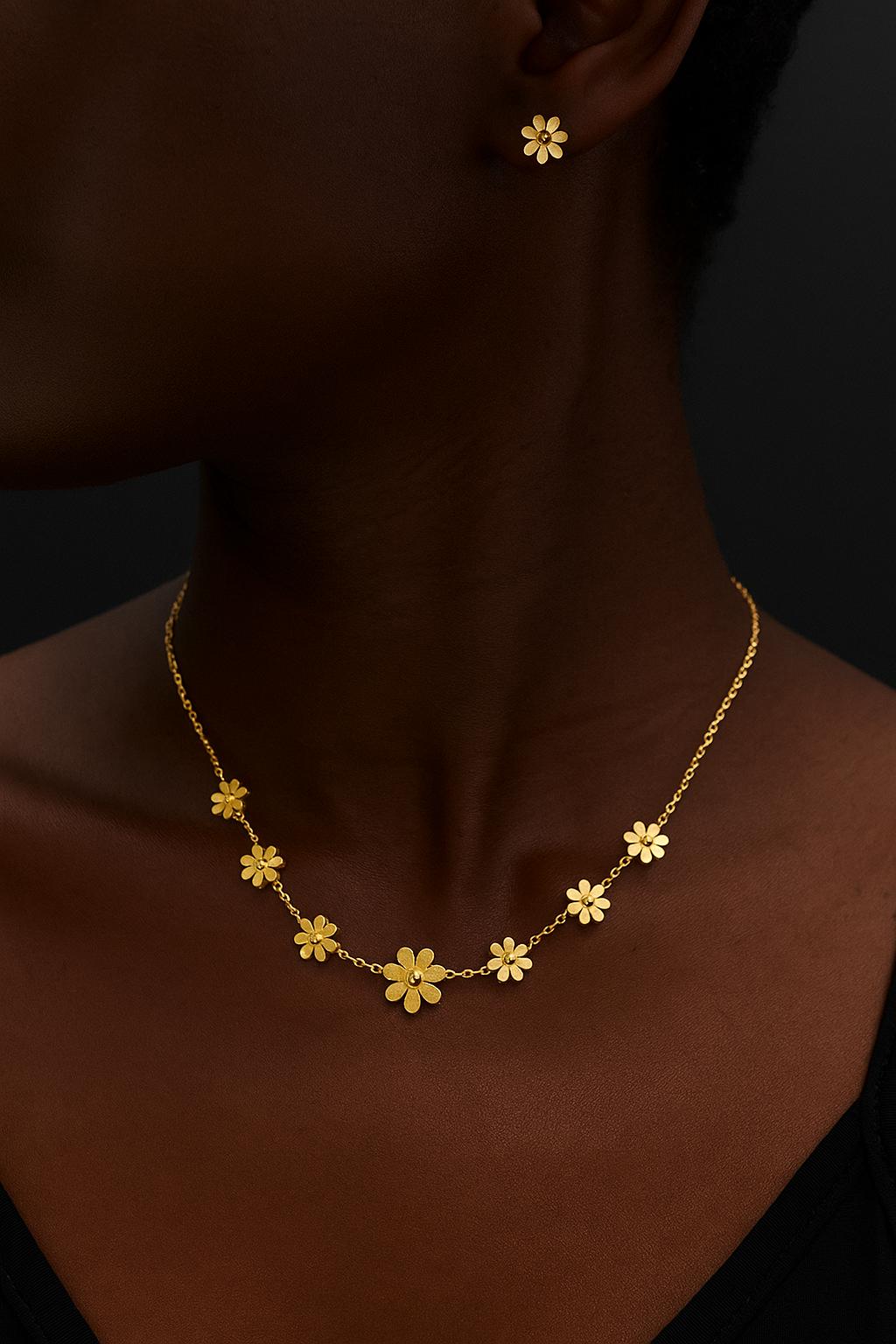 Close-up of a person wearing Sunflower Necklace / stud earring set featuring delicate gold flower-shaped studs and matching necklace, elegant luxury accessories.