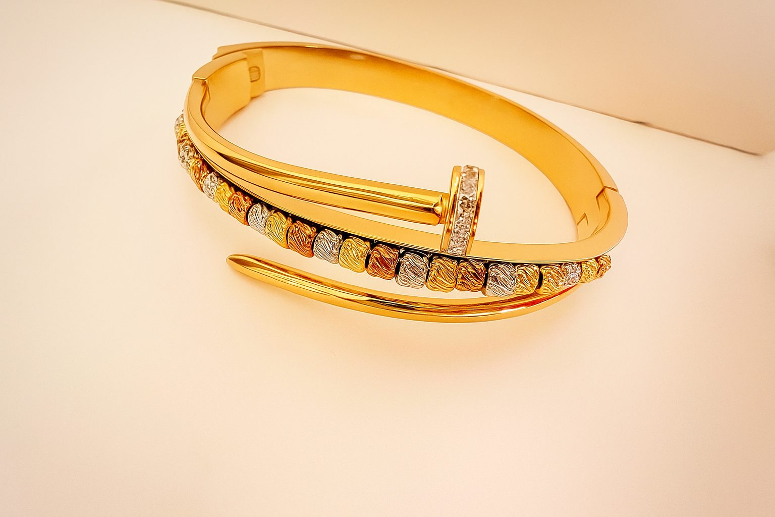 Gold Bronze Bangle featuring a sleek, modern design with a blend of gold and bronze tones accented by small textured details and subtle sparkle, ideal for luxury jewellery collections.