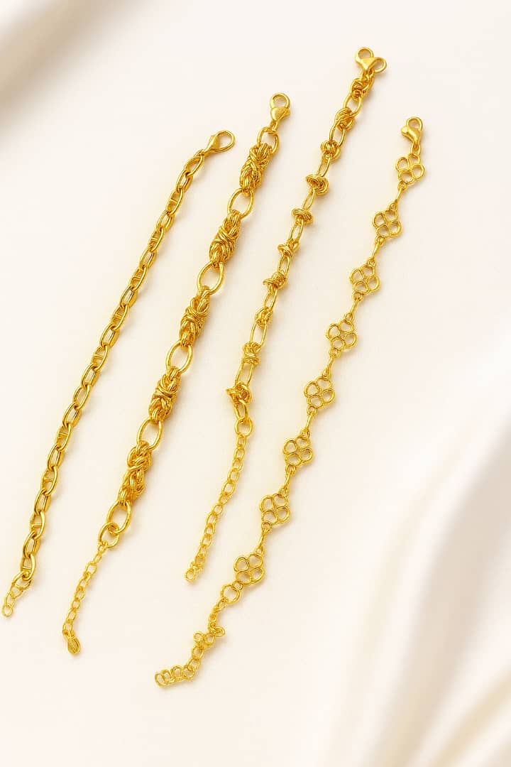 Baddie Bracket Stack featuring four 18K gold plated bracelets with unique link designs, perfect for layering and adding a touch of luxury to any outfit.