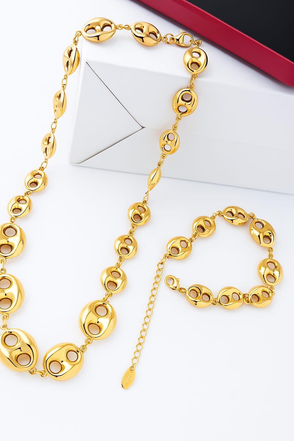 Gold-Plated Necklace & Bracelet Set featuring polished round linked elements with cutout details, showcased on a white and black background for luxury accessories appeal.